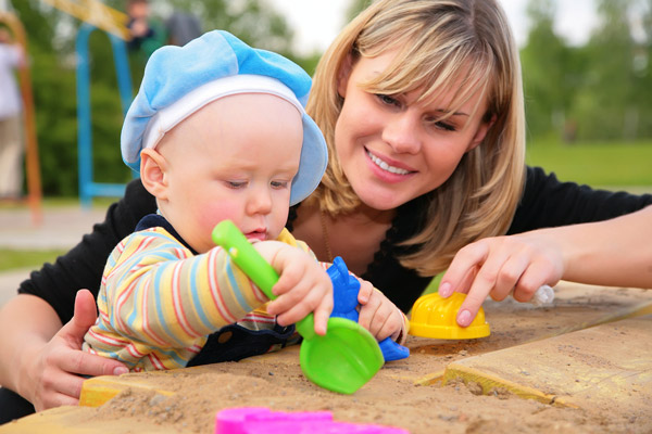 Mother and Child Playing in Sandbox