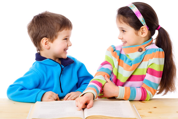 Young boy and girl reading a book
