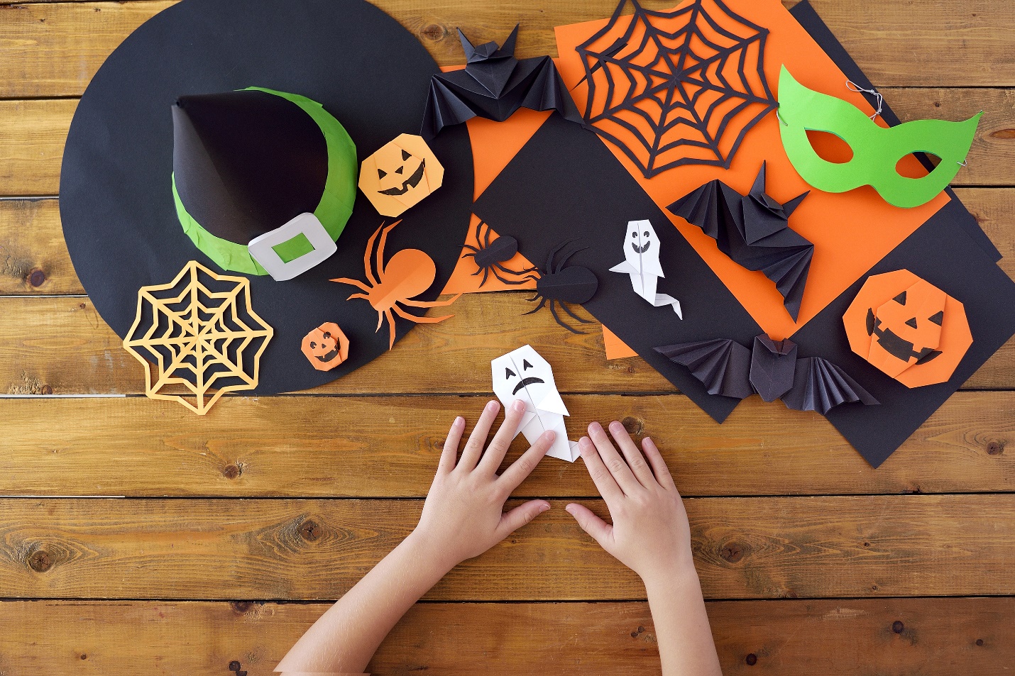 Child making Halloween origami